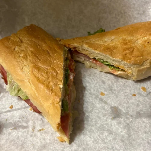 Boricua (Media Noche) - A classic Puerto Rican-style media noche sandwich with savory fillings on sweet bread, pressed to golden perfection.